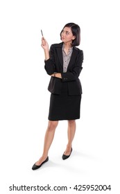 Full Body Portrait Of Young Asian Female Expert Standing, Pointing And Explaining Something With Her Pen, Isolated On White