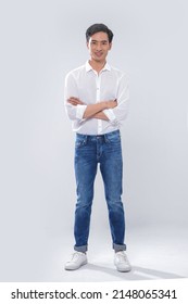 Full Body Portrait Of Young Man Wearing White Shirt With Jeans Standing Posing In Studio