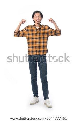 Full body portrait of young man with jeans with winning gesture. Celebrating victory or success.
in studio isolated on white background

