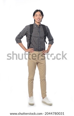 Full body portrait of young man with khaki pants with backpack in studio isolated on white background


