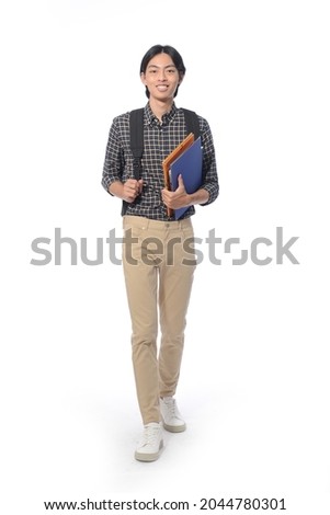 Full body portrait of young man with khaki pants with backpack holding notebook