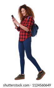 Full Body Portrait Of Young Woman Walking On Isolated White Background With Mobile Phone And Bag