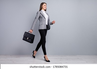 Full body profile photo of attractive lady smiling worker young promoted chief hold diplomat walking company meeting wear specs shirt blazer pants high-heels isolated grey color background