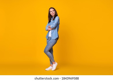 Full Body Profile Photo Of Attractive Confident Lady Arms Crossed Good Mood Look Dreamy Up Empty Space Creative Journalist Wear Casual Denim Shirt Shoes Isolated Yellow Color Background