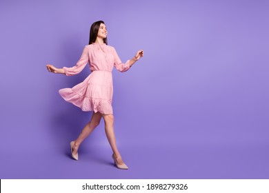 Full body profile photo of cheerful person walking wear retro stilettos isolated on purple color background