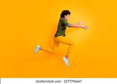 Full Body Profile Photo Of Crazy Dark Skin Curly Lady Jumping Up High Rushing Fast Meet Mom Airport Late Wear Green Dotted Shirt Trousers Shoes Isolated Yellow Color Background