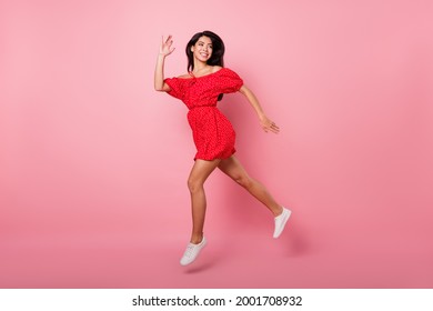 Full Body Profile Photo Of Cute Millennial Lady Run Wave Wear Red Dress Isolated On Pastel Pink Color Background