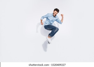 Full body profile photo of funny arabian guy jumping high rejoicing of great win raising fists wear casual denim shirt isolated white color background - Powered by Shutterstock