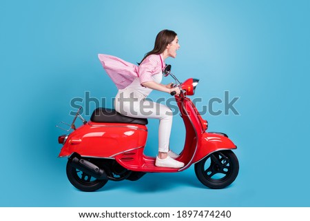 Full body profile portrait of astonished lady speedy drive bike nice journey open mouth isolated on blue color background
