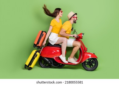 Full Body Profile Portrait Of Two Carefree People Drive Moped Fast Speed Isolated On Green Color Background