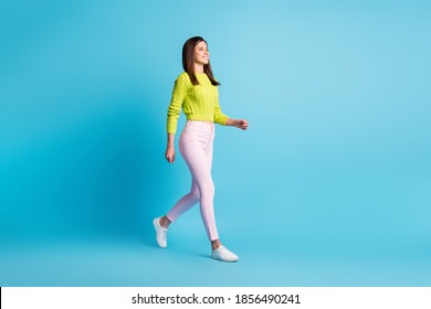 Full Body Profile Side Photo Of Young Attractive Woman Smile Go Walk Look Empty Space Isolated Over Blue Color Background