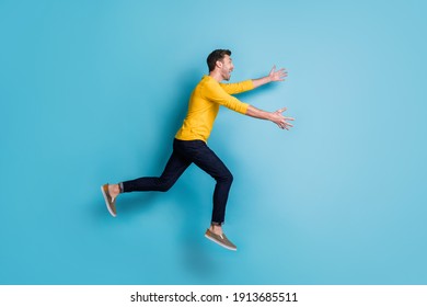 Full Body Profile Side Photo Of Cheerful Man Run Jump Sale Open Hands Wear Casual Clothes Isolated On Blue Color Background