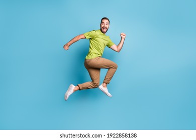 Full Body Profile Side Photo Of Crazy Funky Positive Man Jump Up Run Empty Space Isolated On Blue Color Background