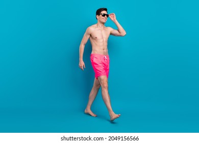 Full Body Profile Side Photo Of Young Man Happy Positive Smile Go Walk Step Wear Sunglass Vacation Isolated Over Blue Color Background