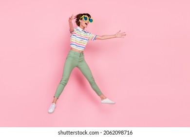 Full Body Profile Side Photo Of Young Girl Striped Top Open Arms Hug Invite Jump Up Sunglass Isolated Over Pink Color Background