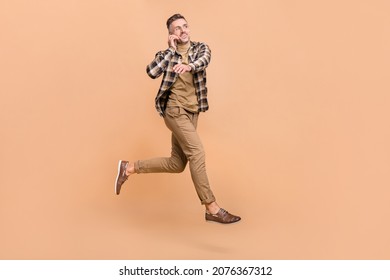 Full Body Profile Side Photo Of Mature Man Talk Mobile Phone Jump Go Busy Rush Isolated Over Beige Color Background