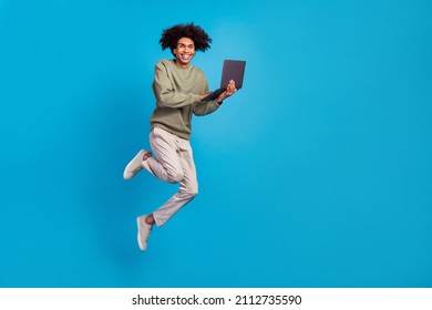 Full Body Profile Side Photo Of Young Man Jump Use Laptop Manager Agent Workshop Energetic Isolated Over Blue Color Background