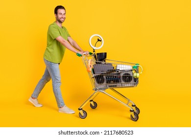 Full Body Profile Side Photo Of Young Man Go Walk Trolley Shop Customer Purchase Swap Thrift Isolated Over Yellow Color Background