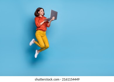Full body profile side photo of young lady type laptop workshop marketer jumper isolated over blue color background