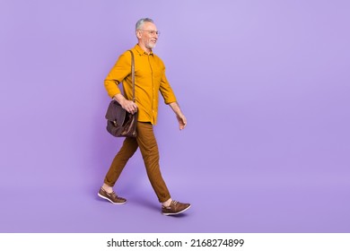 Full Body Profile Side Photo Of Senior Man Walk Look Empty Space Representative Isolated Over Violet Color Background