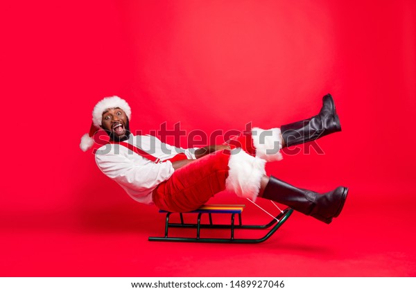 Full body profile side photo of amused african santa claus in xmas cap