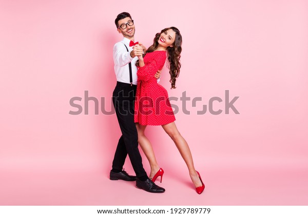 Full body profile side photo of young couple\
happy positive smile dance wear glamour outfit isolated over pastel\
color background