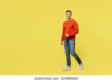 Full body profile young smiling caucasian happy cheerful man wear orange casual clothes walking going look camera isolated on plain yellow color background studio portrait. People lifestyle concept - Shutterstock ID 2254802625