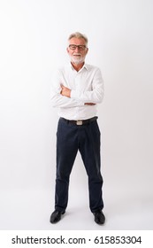 Full Body Shot Of Handsome Senior Bearded Man Standing With Arms Crossed Against White Background