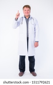 Full body shot of happy overweight man doctor pointing up