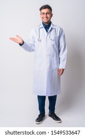 Full Body Shot Of Happy Persian Man Doctor Showing Something