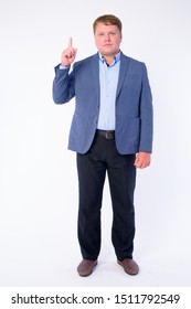 Full Body Shot Of Overweight Businessman In Suit Pointing Up