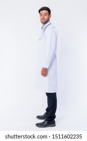 Full Body Shot Profile View Of Young Bearded Persian Man Doctor Looking At Camera