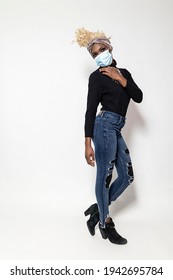 Full Body Shot Of A Thin Attractive Woman In Jeans And Black Shirt With A Mask On A White Background