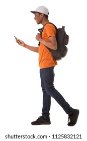 Full Body Side Portrait Of Young African American Man Walking On Isolated White Background With Cellphone And Bag