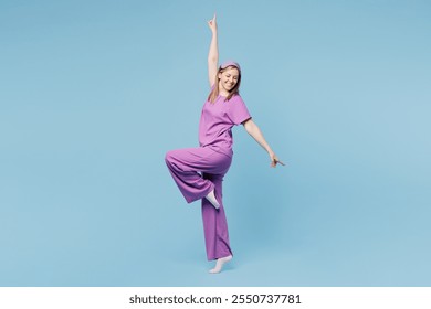 Full body side profile view calm happy cheerful young woman wear purple pyjamas jam sleep eye mask rest relax at home raise up hands isolated on plain blue cyan background. Good mood night nap concept