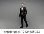 Full body side view adult successful employee business man corporate lawyer he wears classic formal black suit shirt tie work in office look camera isolated on plain grey background studio portrait