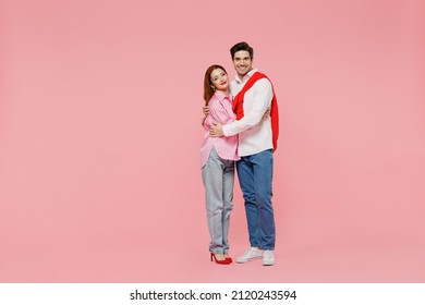 Full Body Side View Happy Young Couple Two Friends Woman Man In Shirt Look Camera Hug Cuddle Isolated On Plain Pastel Pink Background Studio Portrait. Valentine's Day Birthday Holiday Party Concept