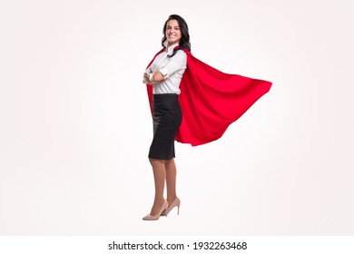 Full body side view of positive successful business lady in elegant formal outfit and red superhero cloak looking at camera against white background - Powered by Shutterstock