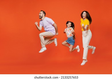 Full Body Side View Young Happy Parents Mom Dad With Child Kid Daughter Teen Girl In Basic T-shirts Run Fast Hurry Up Jump High Isolated On Yellow Background. Family Day Parenthood Childhood Concept.