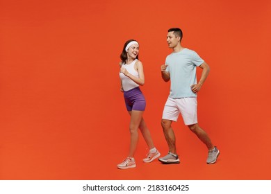 Full body side view young fitness trainer instructor sporty two man woman in headband t-shirt running jog spend weekend in home gym isolated on plain orange background. Workout sport lifestyle concept - Powered by Shutterstock