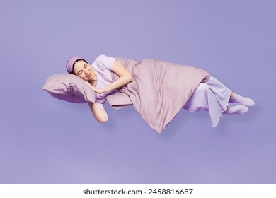 Full body side view young calm woman wear pyjamas jam sleep eye mask rest relax at home fly up hover over air fall down isolated on plain pastel light purple background. Good mood night nap concept - Powered by Shutterstock