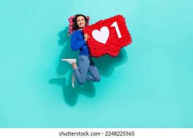 Full body size photo of jumping have fun crazy girl curly hair hold paper like symbol enjoy her insta blog isolated on aquamarine color background