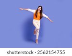 Full body size photo of young school girl preteen flying arms wings try make balance overjoyed have fun isolated on violet color background