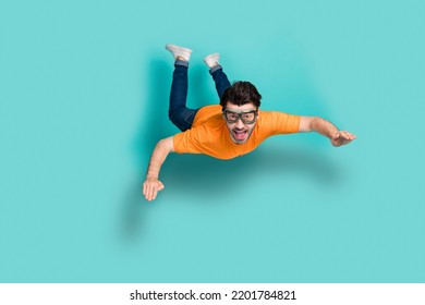 Foto de tamaño completo del cuerpo joven divertido excitado tipo positivo usar gafas saltar el aire trampolín de la caída libre aislado en el fondo de color aguamarina