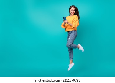 Full body size photo of young adorable pretty nice woman summer casual outfit hold phone blogger instagram empty space isolated on cyan color background