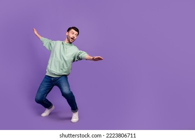 Full body size photo of youngster man student carefree get balance dance funny excited look empty space abyss dangerous isolated on violet color background