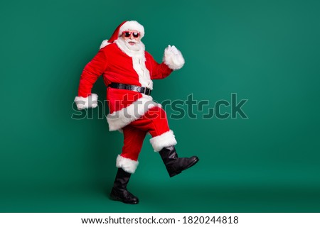 Full body size profile photo of retired grandpa funny walk together elves deer buy present gift kids wear red santa costume coat gloves sunglass cap isolated green color background