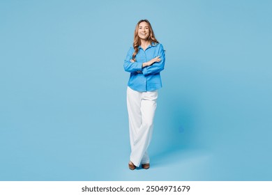 Full body smiling happy cheerful young woman she wear shirt casual clothes hold hands crossed folded look camera isolated on plain pastel light blue cyan background studio portrait. Lifestyle concept - Powered by Shutterstock