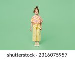 Full body smiling happy fun cheerful little child kid girl 6-7 years old wear casual clothes look camera isolated on plain pastel green background studio. Mother