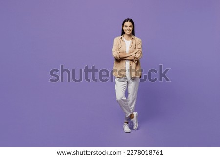 Full body smiling happy fun young latin woman wear light shirt casual clothes hold hands crossed folded look camera isolated on plain pastel purple color background studio portrait. Lifestyle concept